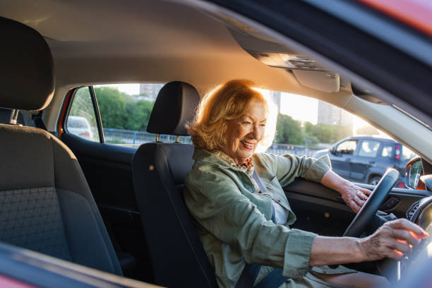istock Senior woman having fun driving a car 2152317451