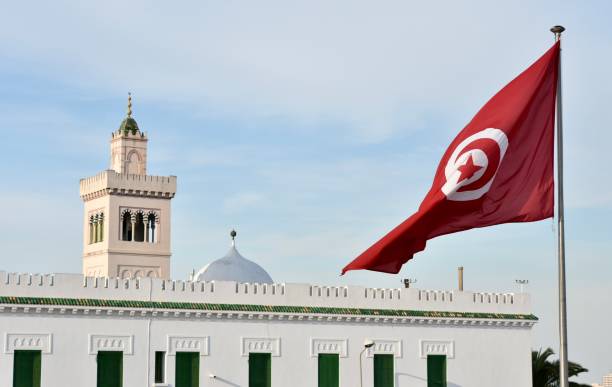 istock Tunisian Flag in Kasbah Monument Square with Square Minaret in Left Background 2152318949