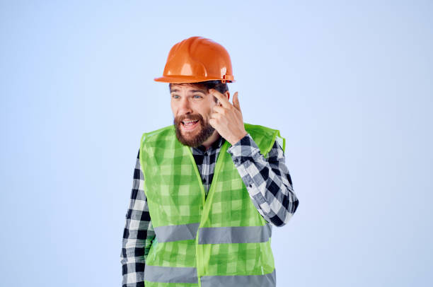 istock bearded man green vest orange helmet workflow hand gestures Studio 2152322387