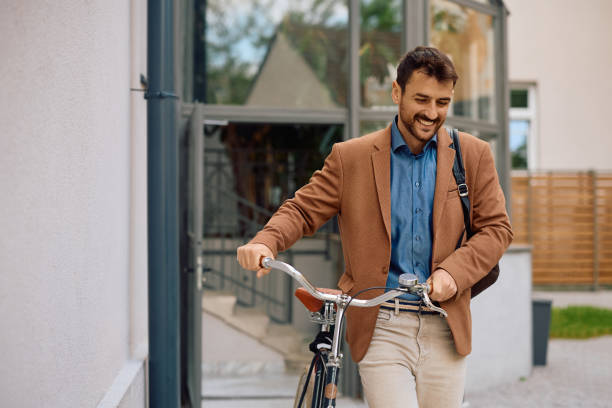 istock Happy entrepreneur with bicycle leaving the office building. 2152322424