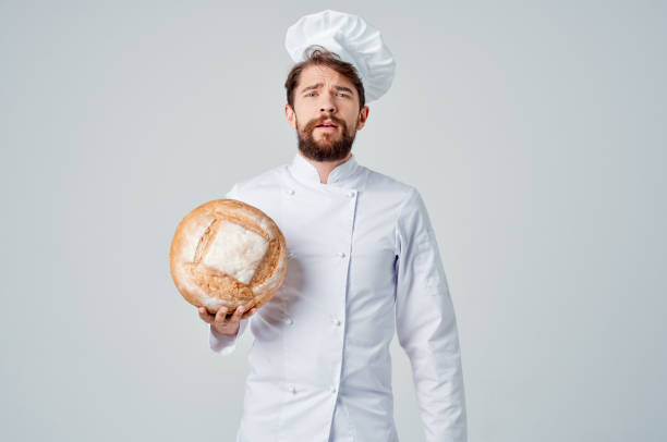 istock bearded man chef with bread in hand Professional emotions 2152322863