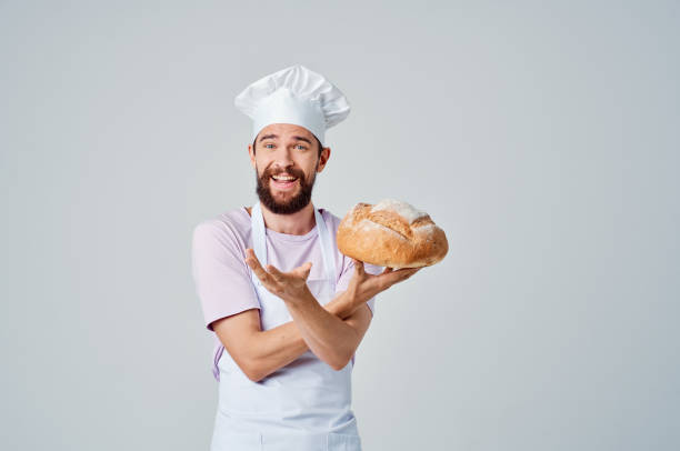 istock emotional Baker in a White apron with bread in his hands Professional 2152322946
