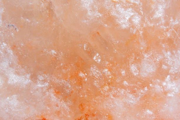 Himalayan salt texture, macro, copy space. Natural salt background. Himalayan coral pink rock salt, closeup.