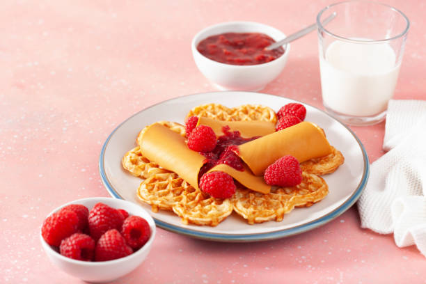 istock waffles with Norwegian brunost traditional brown cheese and raspberry jam 2152326144