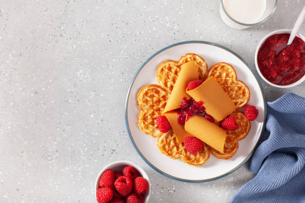 istock waffles with Norwegian brunost traditional brown cheese and raspberry jam 2152326150