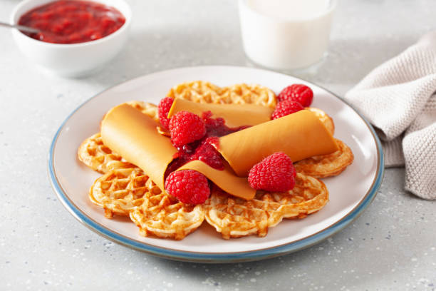 istock waffles with Norwegian brunost traditional brown cheese and raspberry jam 2152326156