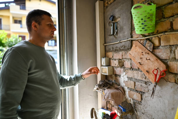 Man repairing automatic garage door.