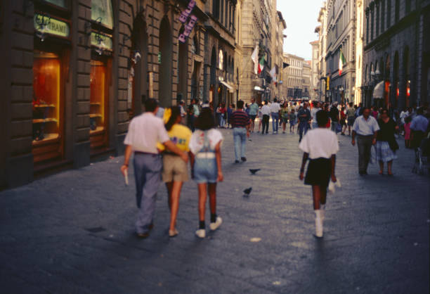 Florence, Tuscany, Italy, 11 August 1992: walking along Via dei Calzaiuoli full of shops and the main street of the city center that connects the cathedral with Piazza della Signoria