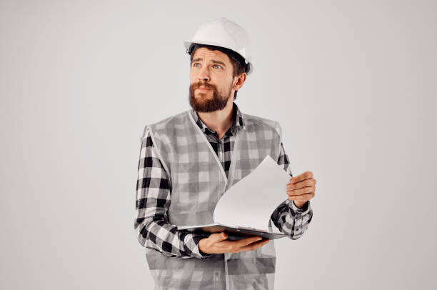 istock male worker in a white helmet blueprints Professional light background 2152329329