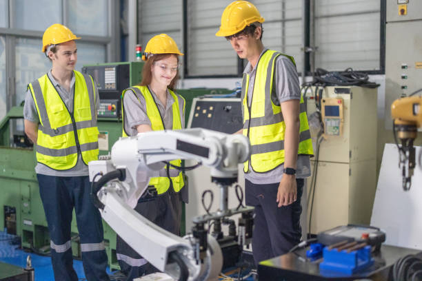 istock Trainees master robotics with hands-on workshops and quality control in manufacturing academy. 2152330519