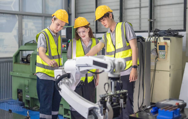 istock Trainees master robotics with hands-on workshops and quality control in manufacturing academy. 2152330784