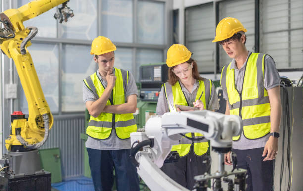 istock Trainees master robotics with hands-on workshops and quality control in manufacturing academy. 2152331537