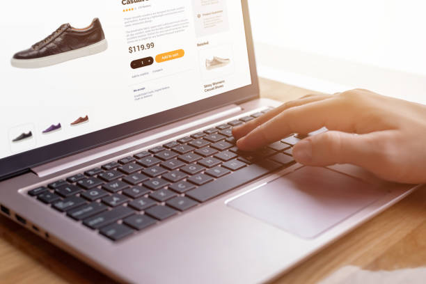 istock Hands on keyboard searching for modern shoes. E-commerce interface concept. Seamless digital shopping experience for shoe enthusiasts 2152332299