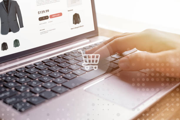 istock Hands shopping online on laptop with shopping cart icon. E-commerce web page displayed. Modern digital shopping experience for convenient purchasing 2152332349