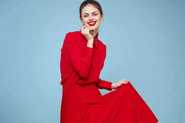 attractive woman in bright clothes on blue background gesturing with hands and red lips makeup cropped view emotions. High quality photo