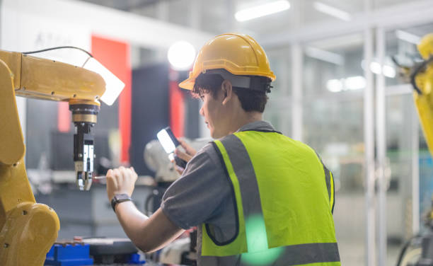 istock Trainees master robotics with hands-on workshops and quality control in manufacturing academy. 2152333327