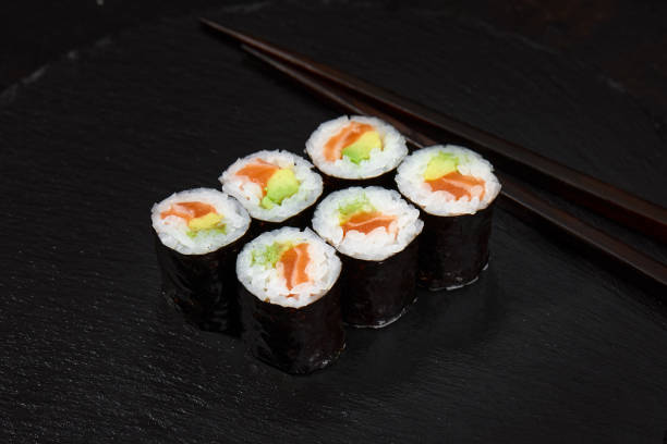 istock Set of tuna sushi rolls on black desk background 2152333428