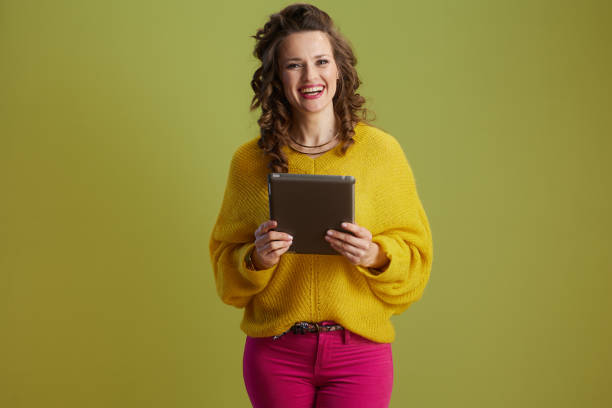 istock happy healthy woman using tablet PC isolated on green 2152333478