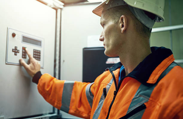 istock Button, panel and man in electricity maintenance for industrial grid inspection at windmill. Renewable energy, engineering contractor or technician with safety for electrical circuit at power station 2152333753