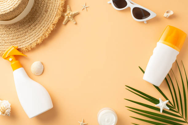 istock An arrangement of summer beach essentials on beige background, featuring sunscreen sprays, sunglasses, a straw hat, and starfish 2152338201