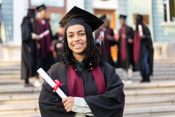 istock A happy student in mortarboards and bachelor gowns with diploma 2152341948