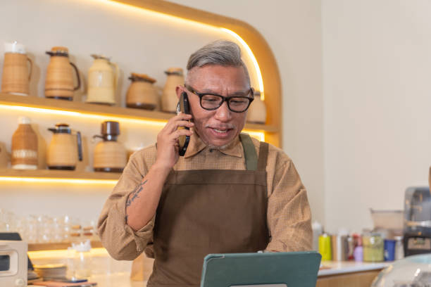 istock Asian senior taking online order from customer 2152342215