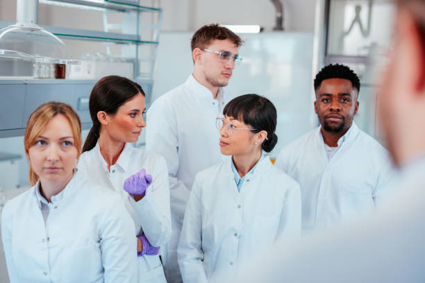 istock Two scientists looking at each other during a meeting 2152342427
