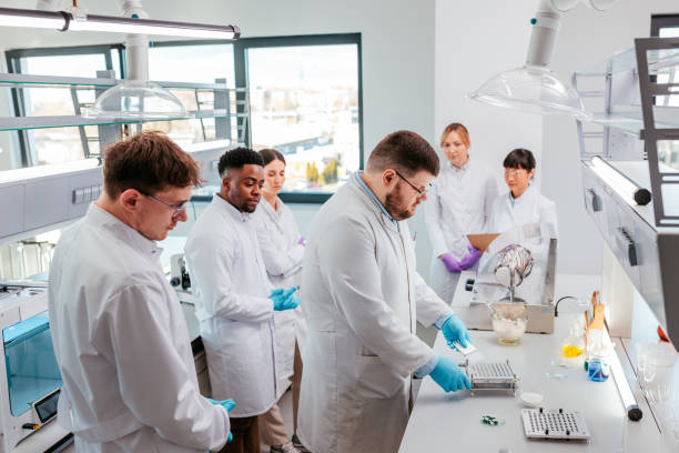 istock Scientist showing colleagues how to make medications 2152342474
