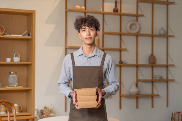 istock Asian business waiter holding box container 2152343824