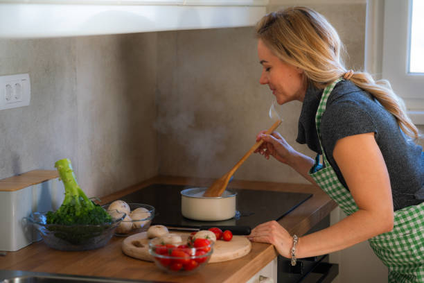 istock Woman boiling water for lunch in the kitchen 2152349288