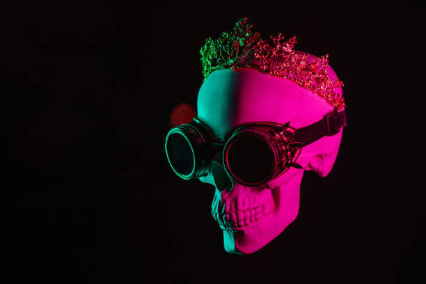 istock human skull in steampunk glasses and crown with pink green light 2152349773