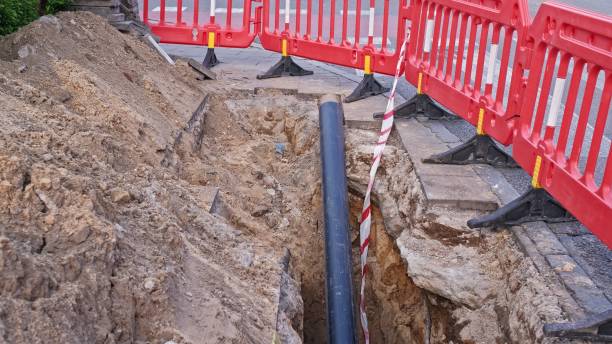 istock Gas PVC Pipe Exposed at Roadworks Construction Dig Site Secured with Temporary Red Safety Barrier 2152353103