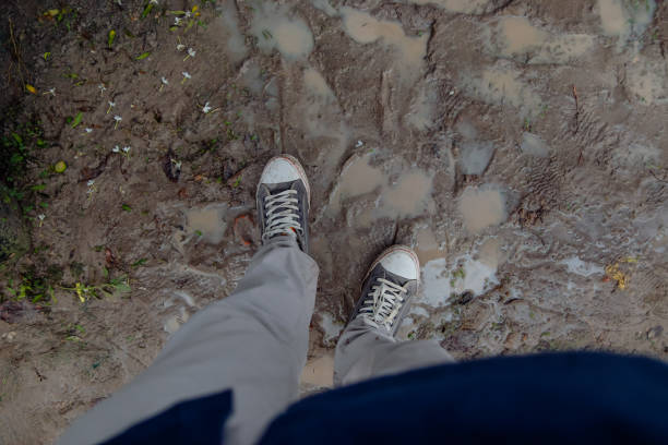istock Dirty shoes exposed to wet soil 2152354819