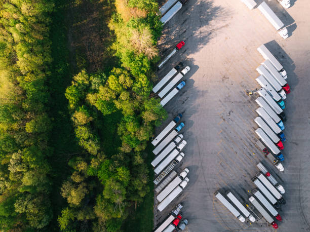 istock Drone View directly above Semi Trucks Parked at a Rest Stop, juxtaposition with Green Trees and nature in Kentucky, USA 2152359759
