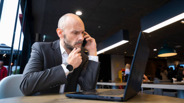 istock A middle-aged handsome businessman working with his laptop outside the office environment 2152360850