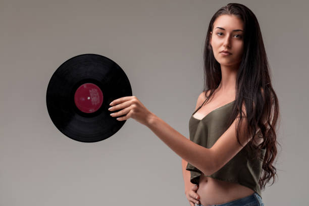 istock Confident woman holds vinyl, style and grace 2152361017
