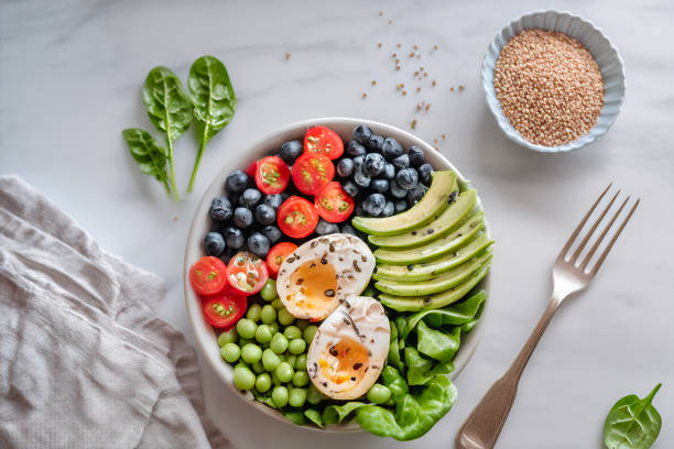 istock Buddha bowl with avocado, egg, chickpeas, tomato, cucumber, spinach and blueberries 2152361258