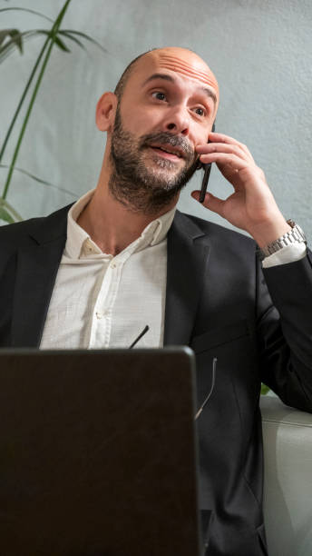 istock A middle-aged handsome businessman working with his laptop outside the office environment 2152361285