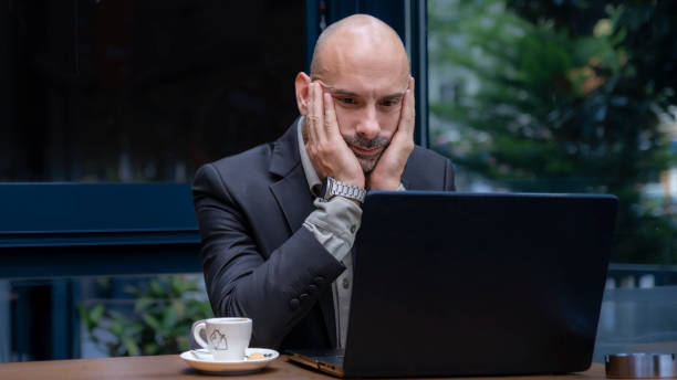 istock A middle-aged handsome businessman working with his laptop outside the office environment 2152365004