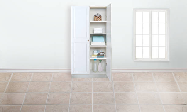 Laundry room with linen cabinet and tile floors