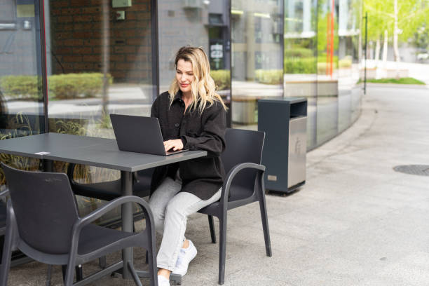 istock Young woman with laptop outside 2152376269