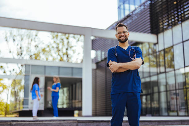 istock Male nurse with stethoscope standing at clinic. 2152376426