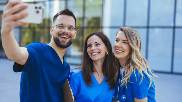 istock Happy young people, wearing scrubs, having fun together as they study medicine. 2152376498