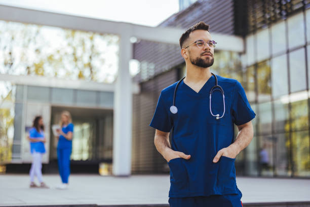 istock Male nurse with stethoscope standing at clinic. 2152376746