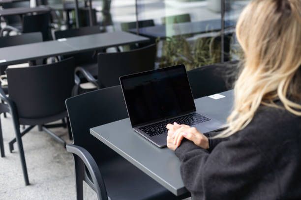 istock Young woman working at a remote job in a cafe 2152376853
