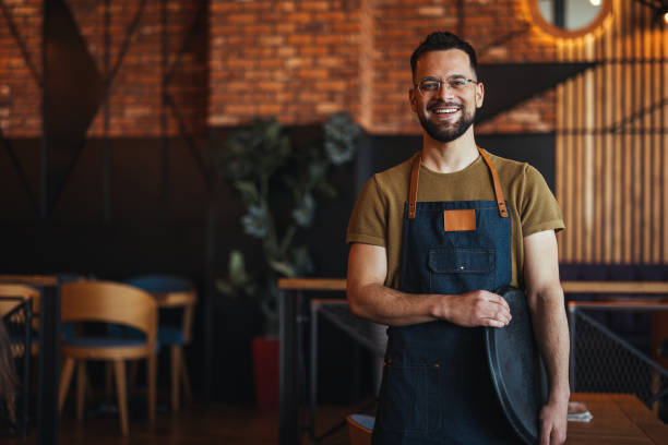 istock Happy confident young waiter entrepreneur looking at camera 2152377048