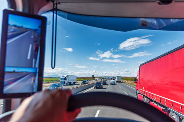 istock Overtaking from one truck to another on a highway crowded with vehicles, seen from inside the truck that is traveling faster. 2152377150