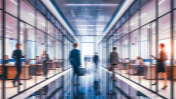 istock Business people walking in office, blurry working space with defocused effect, blurred motion business background 2152377368