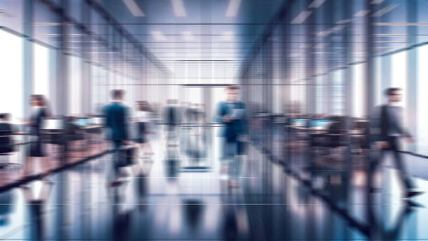 istock Business people walking in office, blurry working space with defocused effect, blurred motion business background 2152377376