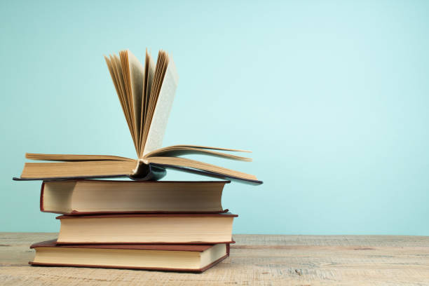 istock open book on a wooden table. Back to school. Education business concept. 2152379080